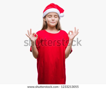 Young beautiful girl wearing christmas hat over isolated background relax and smiling with eyes closed doing meditation gesture with fingers. Yoga concept.