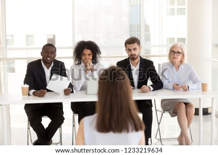 Serious focused diverse hr recruiting people group listening applicant performance at job interview, multi-ethnic recruiters team make decision consider hiring seeker thinking about first impression Royalty-Free Stock Photo #1233219634