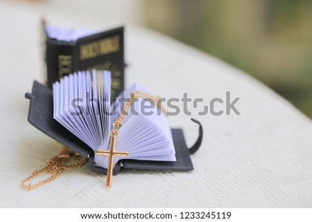 Gold Christ cross lace with holy bible, black cover. European religion conceptual for Christian faith, pray and hope
