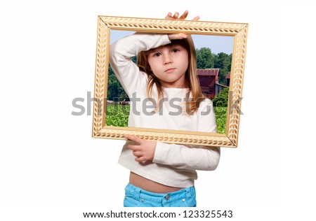 Beautiful little girl looking through an ornate picture frame