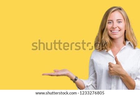 Beautiful young business woman over isolated background Showing palm hand and doing ok gesture with thumbs up, smiling happy and cheerful