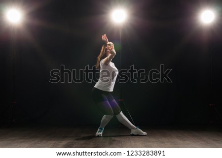 People and dancing concept - Pretty woman dancing jazz funk over dark background