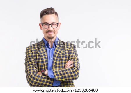 Handsome man in jacket with beard and mustache in glasses having his arms crossed, standing over white background with copy space
