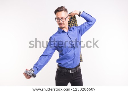 Retro camera, photography and people concept - Portrait of young handsome man taking a selfies over white background