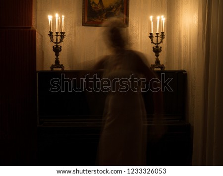 Ghost woman in room with candles