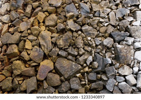Rocks on the beach in two toned colours, orange saturated on the left and bright white on the right