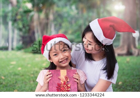 Asian Daughter and mother smiling with happy in merry christmas day or Xmas celebrate