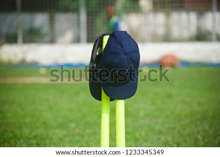 Two caps kept on the plastic cricket stumps unique photo