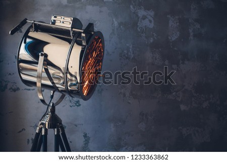theater spot light with smoke against grunge wall.