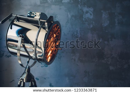 theater spot light with smoke against grunge wall.
