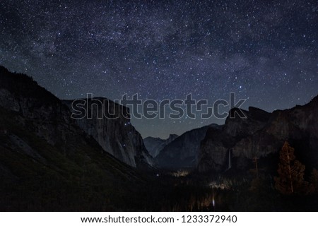 The Milky Way is seen spread out over the night sky over Yosemite National Park's iconic Tunnel View, California, USA