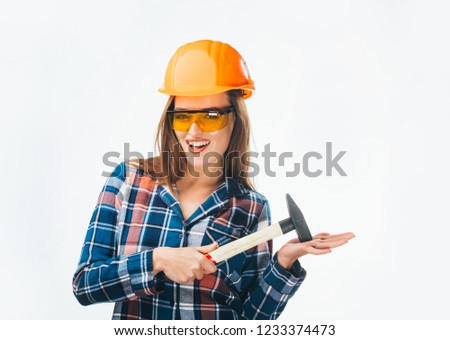 Young happy attractive girl in building orange helmet and glasses with hammer. Full isolated studio picture from emotional craftswoman.