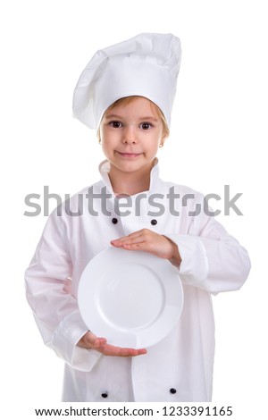 Happy girl chef white uniform isolated on white background. Holding the white plate in the hands in front of herself. Portrait image