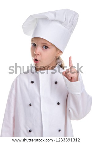 Attentive girl chef white uniform isolated on white background, looking straight at the camera with a pointing finger up. Attention sign. Portrait image