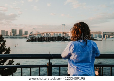 
Beautiful view of Tokyo Bay from the Odaiba district. Happy young woman taking enyoing travelling around Japan. Lifestyle.