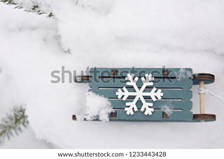 small sledge on real snow in the winter during a snowfall toy sled in the snow