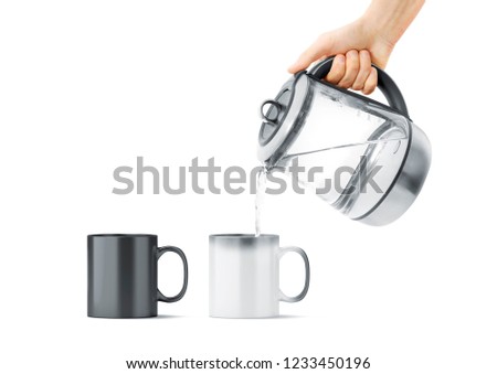 Blank black and white magic mug with hot teapot mockup, isolated. Ceramic cup filling water with kettle in hand mock up, front view. Chameleon utensil for coffee or tea with thermoprint.
