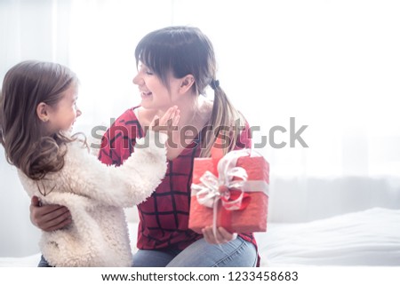 The concept of Christmas and new year, the Daughter gives a gift to her mother, family values