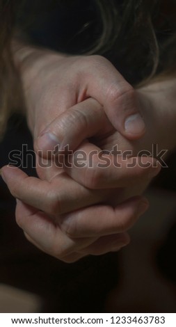 Mental health psychosis and depression photo. Close-up hands shrink from nerves. Toning, low key, selective focus.