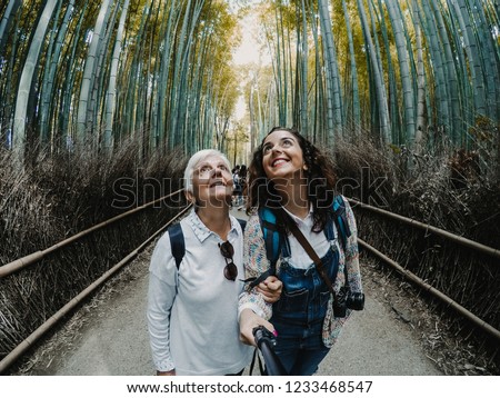 
Mother and daughter touring Japan and taking a picture together. Visiting the bamboo forest located in Arashiyama, Kyoto. Lifestyle. Travel photography.