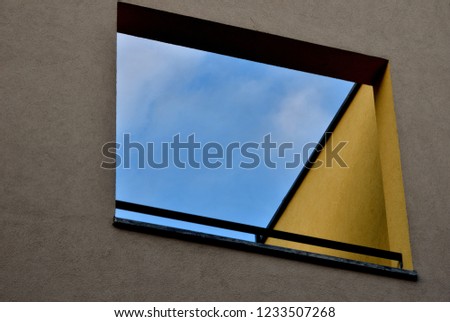 window and blue sky yellow wall