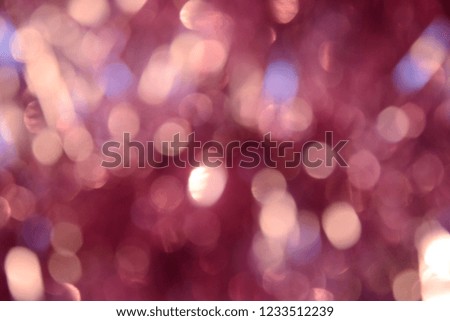 Bokeh photo. Holiday background. Christmas lights. Defocused sparkles. New Year backdrop. Festive wallpaper. Blinks. Carnival. Bokeh retro style photo. Pink.
