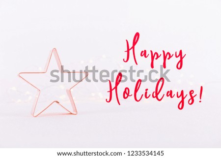 Star Copper cookie cutter on white sparkling background with bokeh lights. Holiday Christmas and New Year card background. Horizontal. Holiday wording