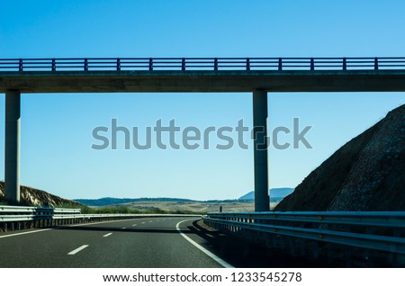 Fast road in the mountains in Spain, beautiful landscape of mountains, dry earth and rock from the sun, transportation