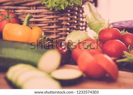 close up point of view table full of fresh vegetables for vegetarian diet and healthyh lifestyle for modern millennial people - colors and mixed vegan food - focus on tomatoes