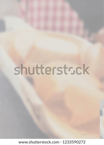 Blurred picture of bread in a a carved out wooden bottle with red and white tablecloth in the background. Opacity 50%. 
Background for restaurant, bar or cafe menus, advertisements, promotions. 