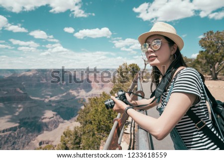 hiker travel lens man sightseeing the beautiful desert mountain relying on the handrail on skyline. young girl tourist wearing straw hat on summer vacation. elegant asian woman travel wild sunny day.