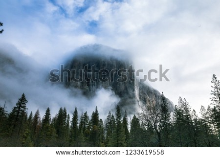 El Capitan blanketed in fog and clouds early in the morning