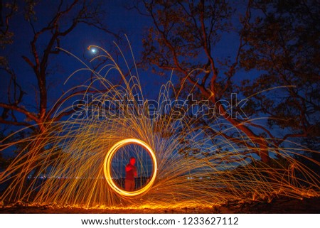 long exposure speed motion abstract of steel wool at twight beside mangrove forest