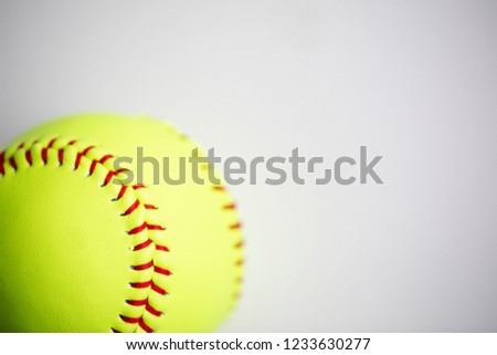 Yellow softball shot on a white background with macro lens