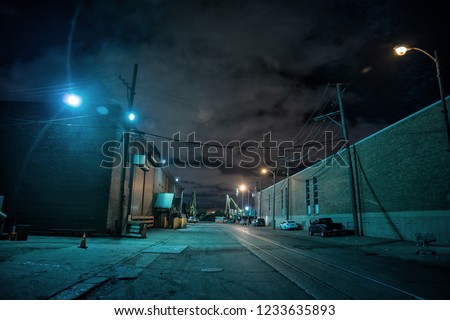 Industrial urban street city night scene with vintage factory warehouses and train tracks Royalty-Free Stock Photo #1233635893