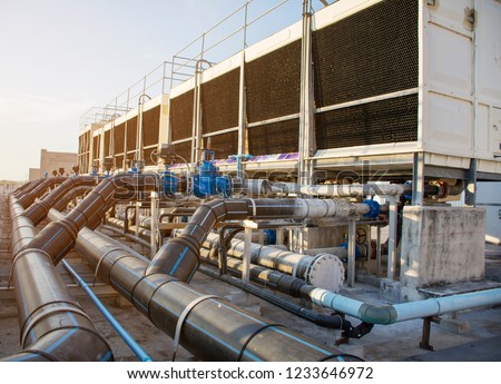 A set of cooling towers in a data center building is installed on the roof. Royalty-Free Stock Photo #1233646972