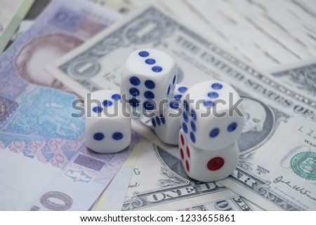 dices on money background - business concept. Very shallow focus.