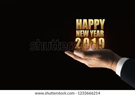 Happy New Year 2019  modern style on the hand of successful business investment man with luxury gold fonts bright light and dark background.