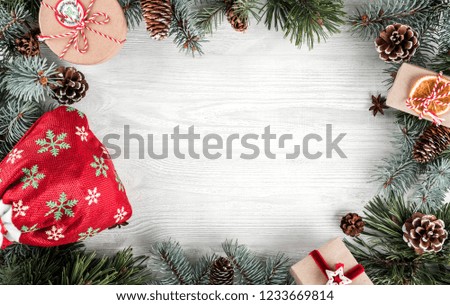 Christmas gift boxes and Christmas bag on white wooden background with Fir branches, pine cones. Xmas and Happy New Year theme. Flat lay, top view