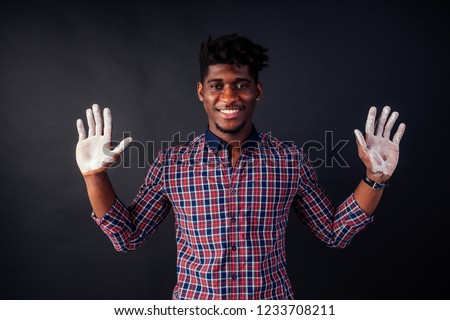 Drunk African American Afro businessman sloppy man with dreadlocks hands up soiled in white powder dust chemical drug police arrest Cuba on a black background in the studio.surrenders to the police