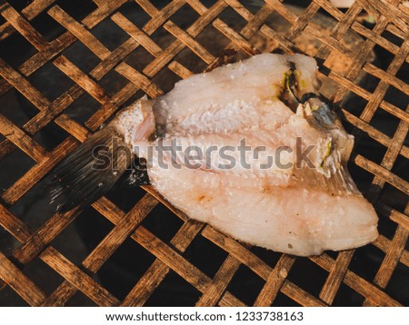 Closeup fish dried on bamboo weaving 