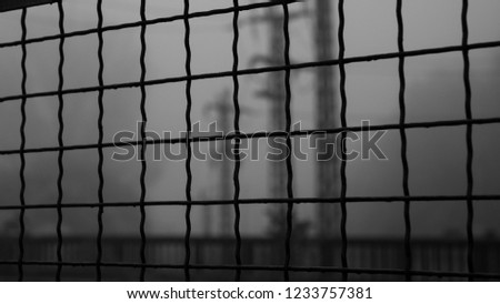 looking at a Train Bridge through a grid on a foggy early morning