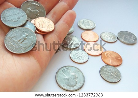 Close up American quarter, dime coins in hand on dollar usa background