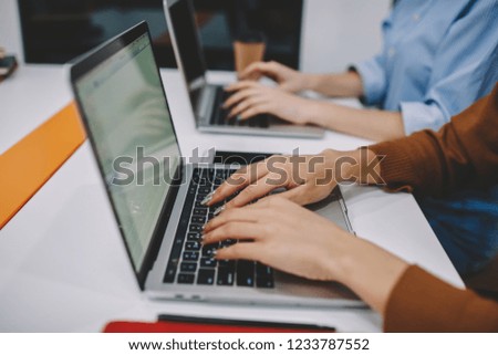 Cropped image of woman's hands typing on laptop computer during online working process, female keyboarding text using netbook for studying and searching information in networks via high speed wifi
