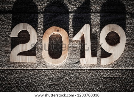 Wooden number 2019 on wooden background. Happy new Year 2019.