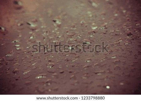 Drops of water on a metal surface for  background. Selective focus.  Shallow depth of field. Toned.