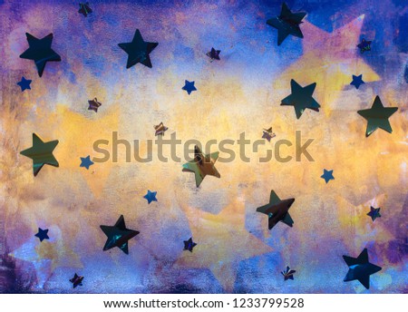 Textured bright colored blue and yellow background with foil stars decoration 