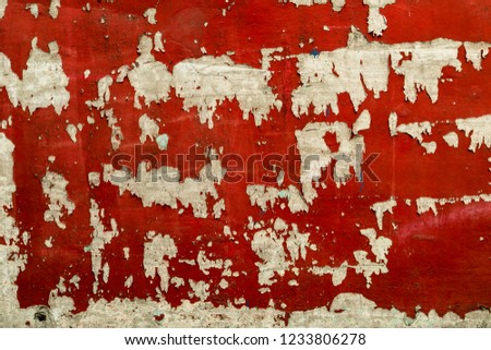 Wall painted red, dirty surface.