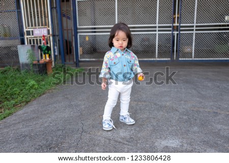Asian girl standing in front of warehouse