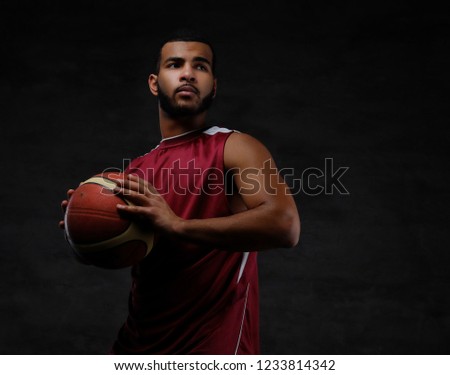 Portrait of an Afro-American sportsman. Basketball player in sportswear with a ball